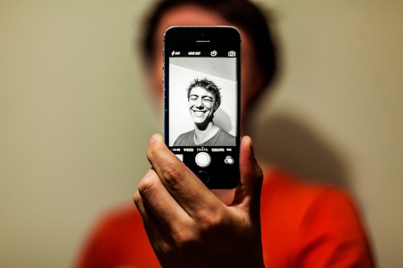 Content creator recording a video selfie on their smartphone